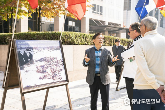 안재철 대표가 광화문을 찾은 외국인들에게 6⸱25전쟁 참상에 대해 설명하고 있다. 